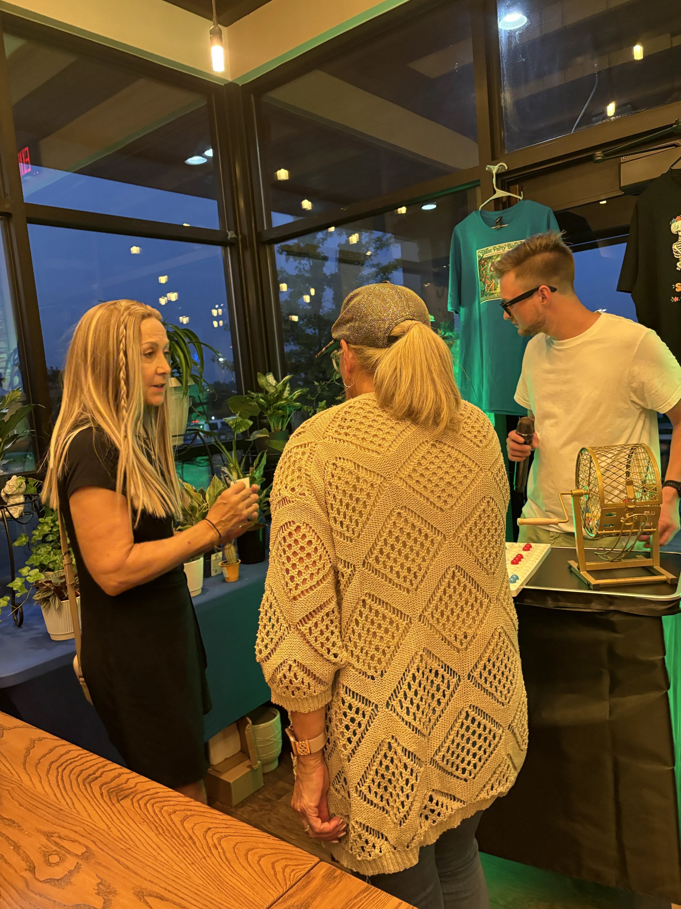Host chatting with guests near the bingo cage at Outback Steakhouse