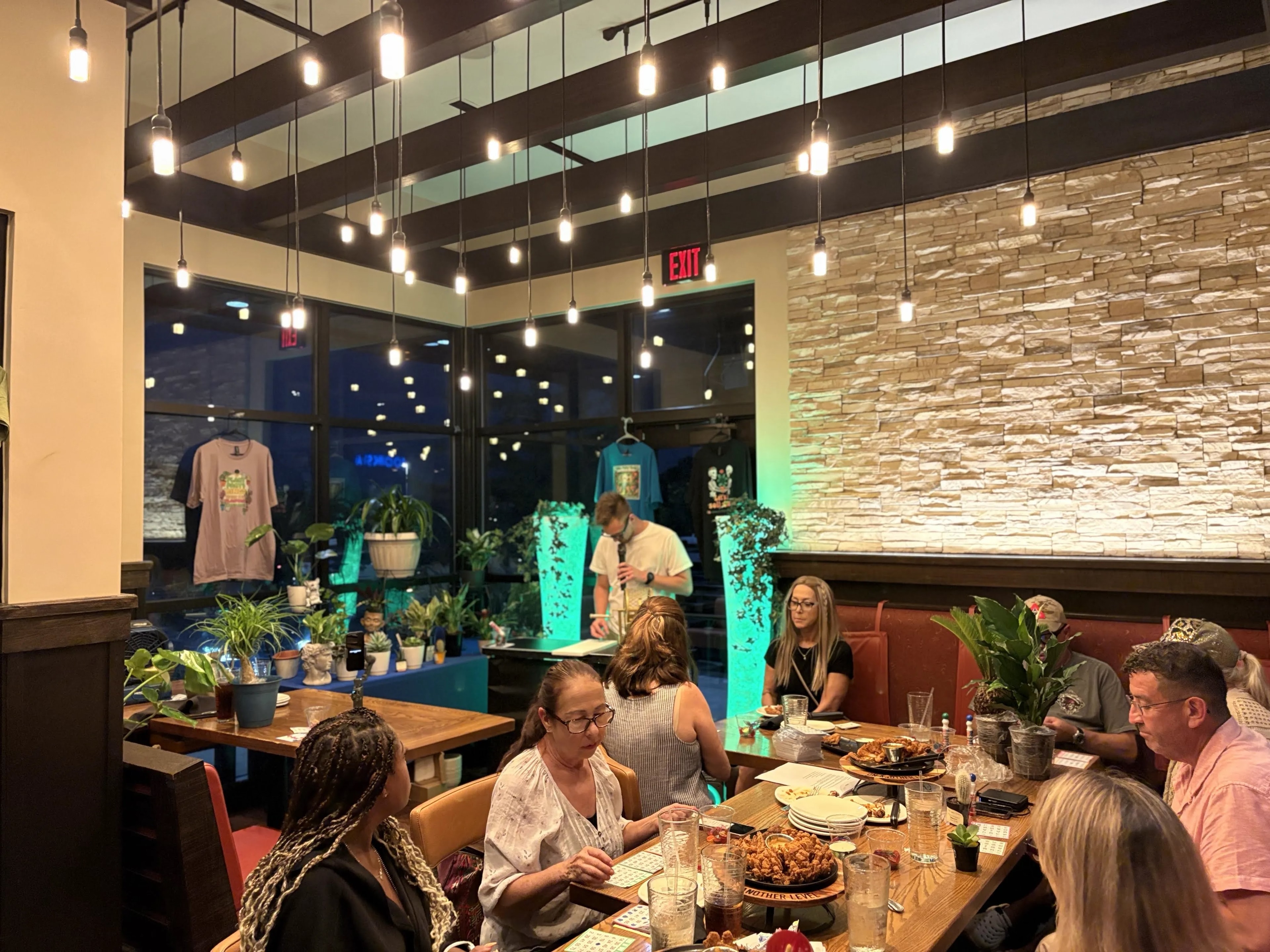Full dining room with guests playing bingo at Outback Steakhouse