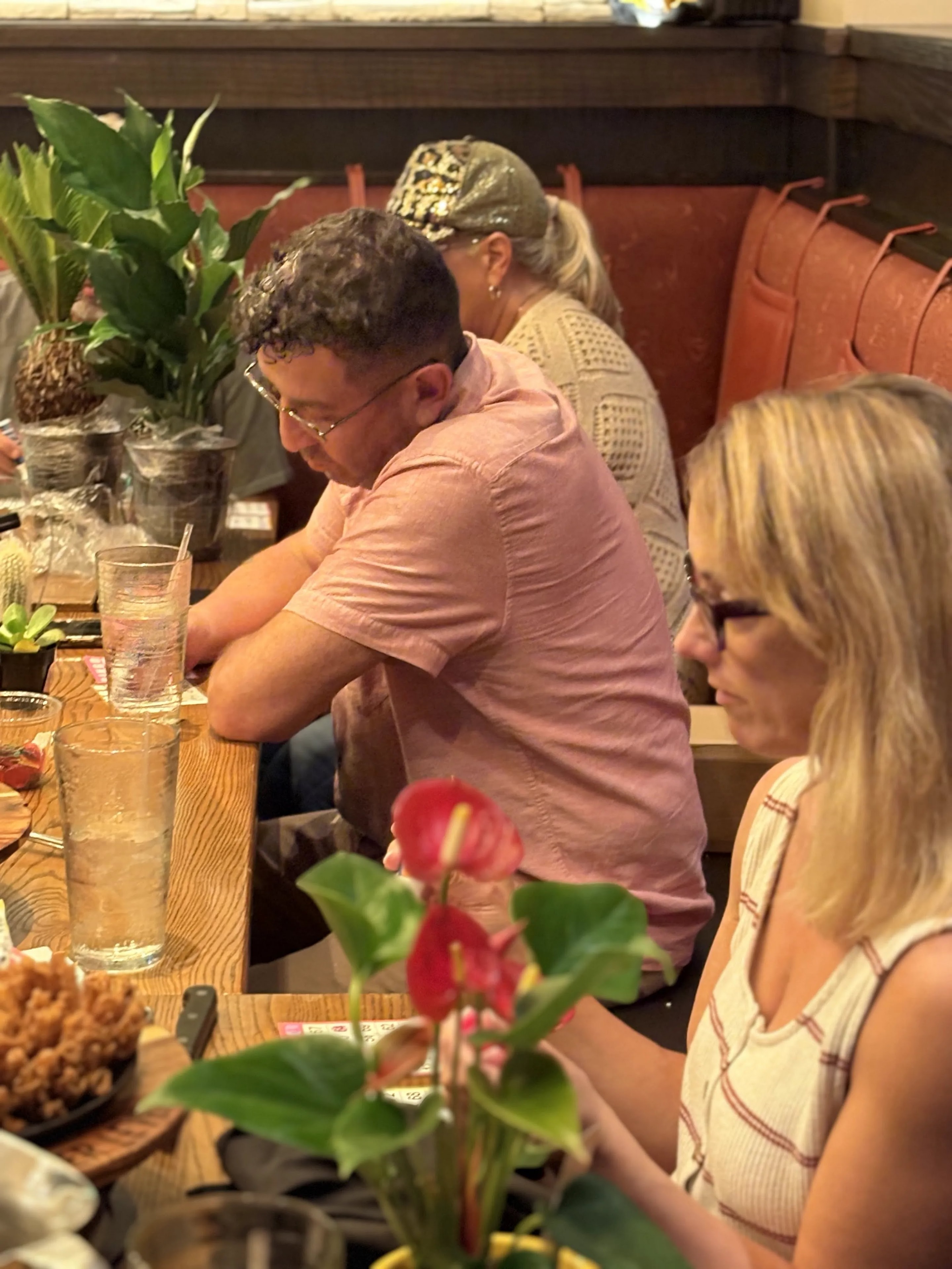 Guests seated at table playing bingo at Outback Steakhouse