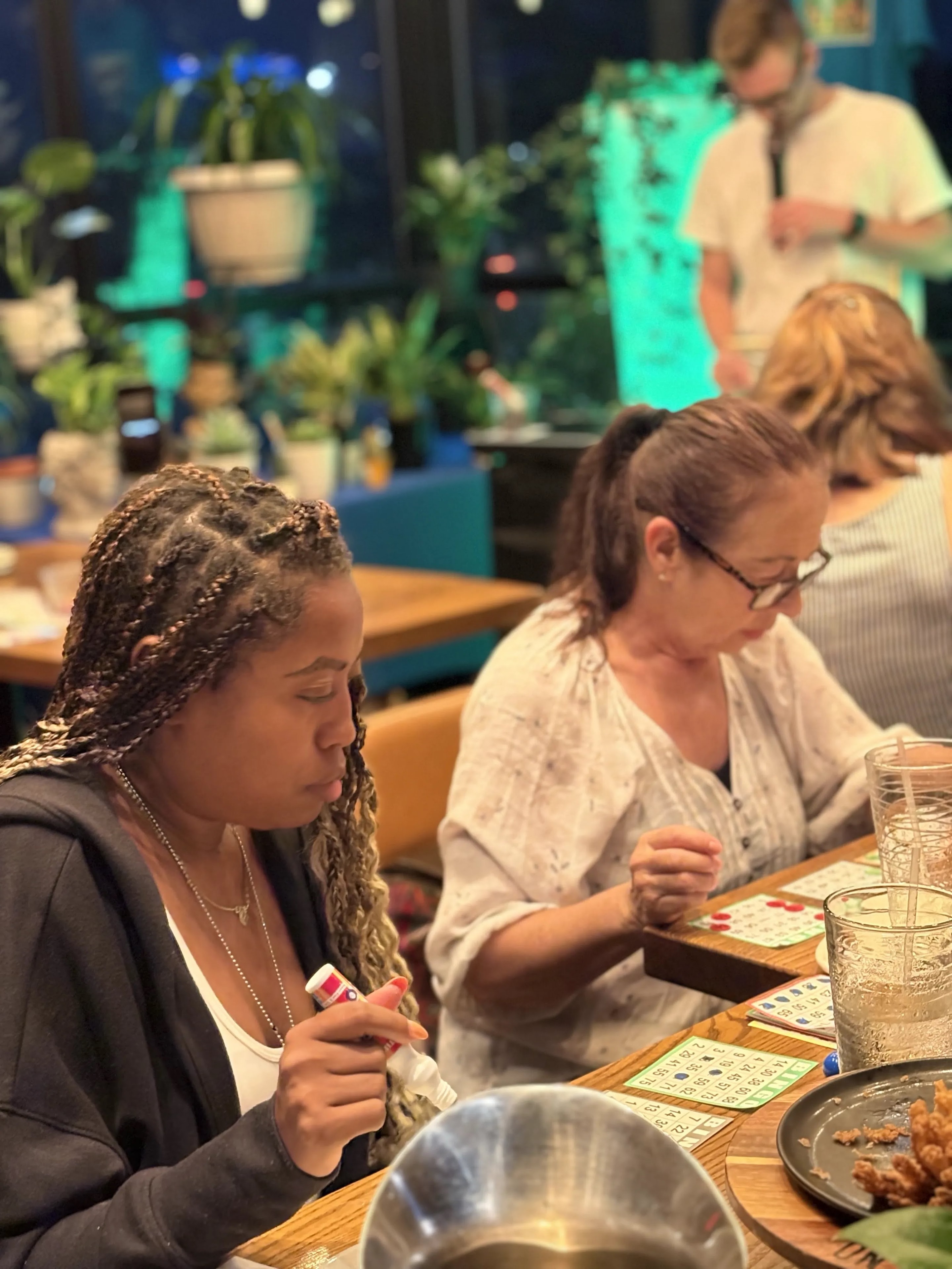 Guests marking bingo cards at Outback Steakhouse
