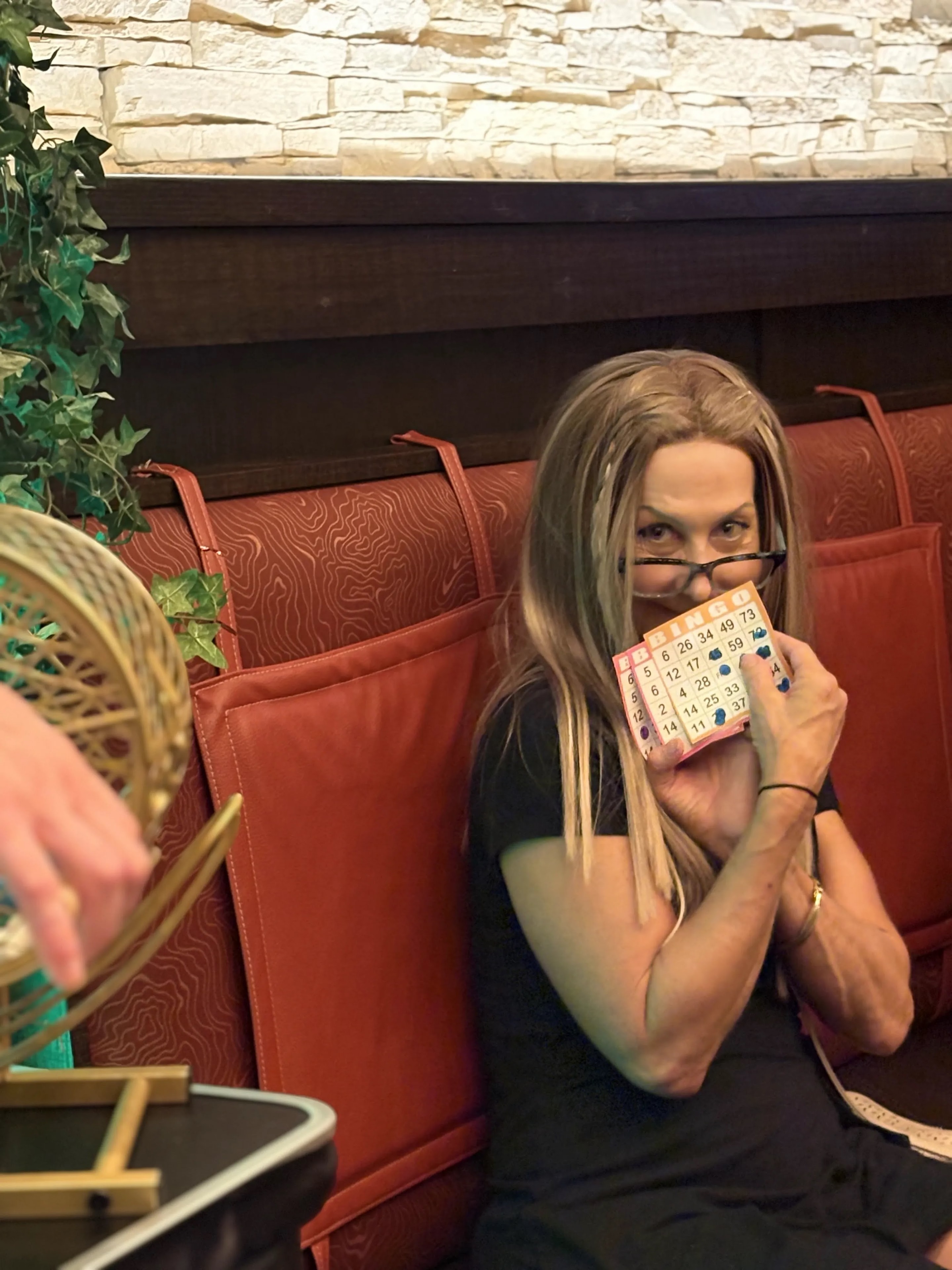 Guest holding up bingo card at Outback Steakhouse