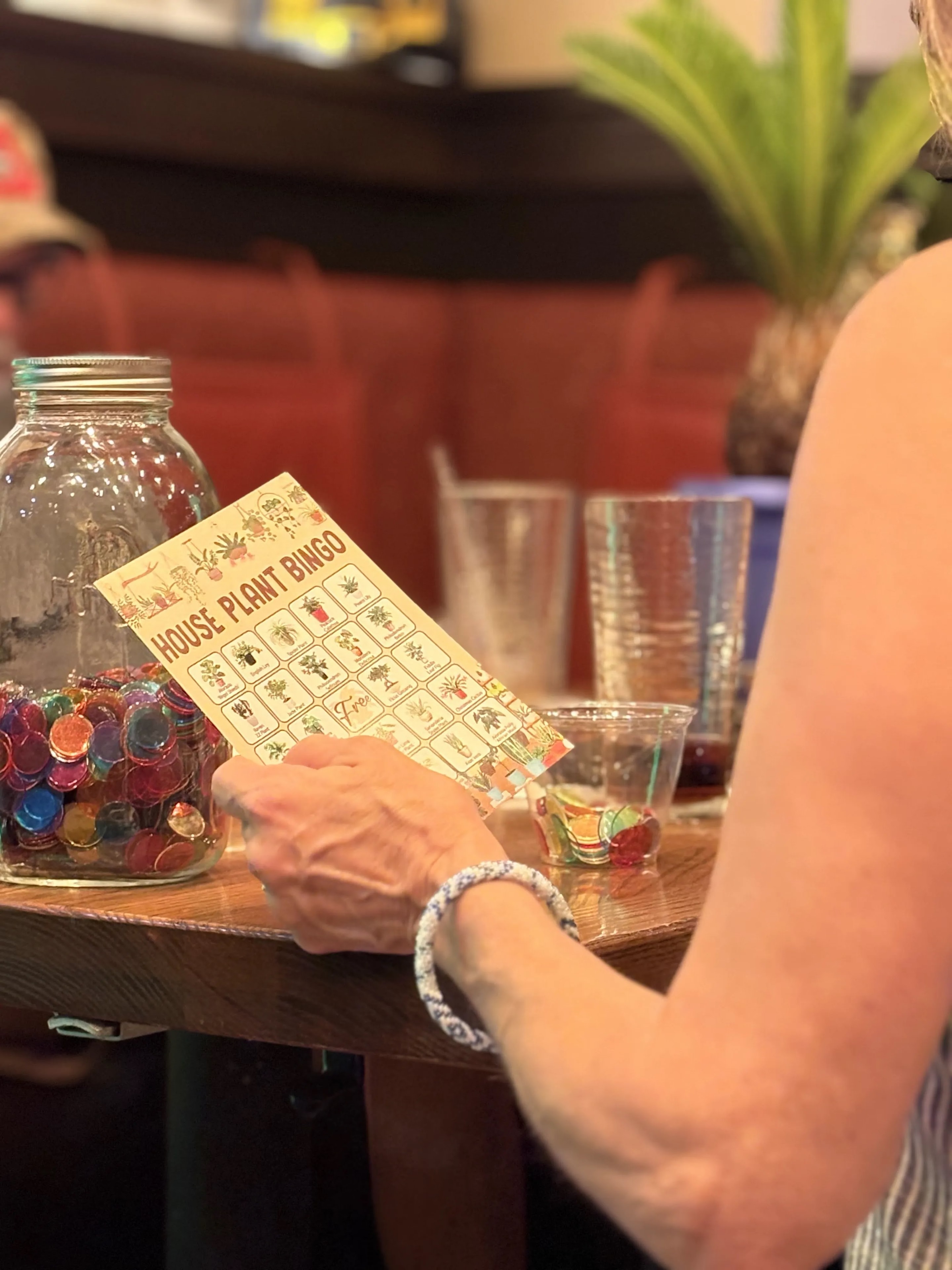 Guest holding House Plant Bingo card at Outback Steakhouse